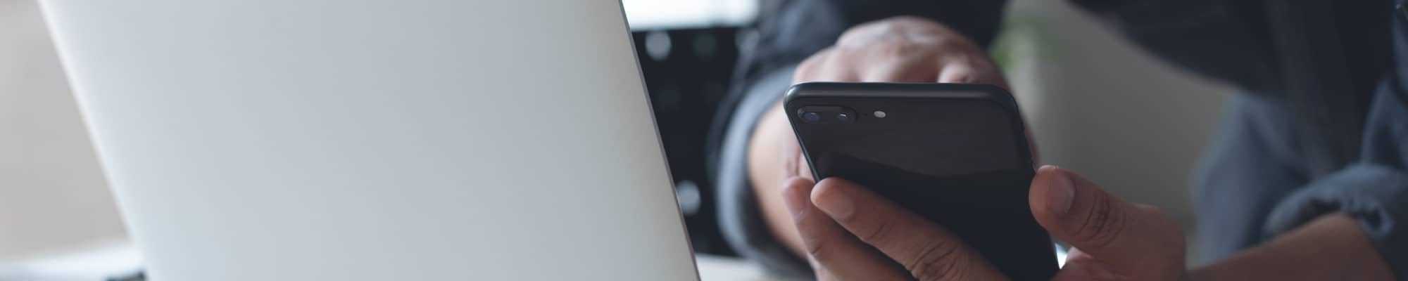 Man using mobile phone and laptop